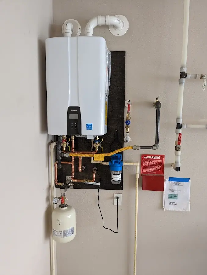 Professional plumber installing copper piping in a Iosco home